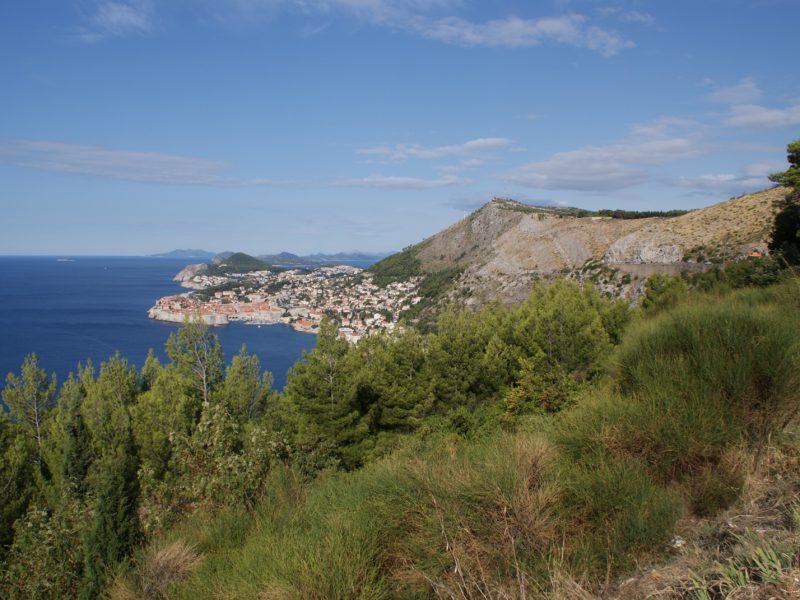 View of Dubrovnik's coastline and hillside from an elevated vantage point overlooking the Adriatic Sea