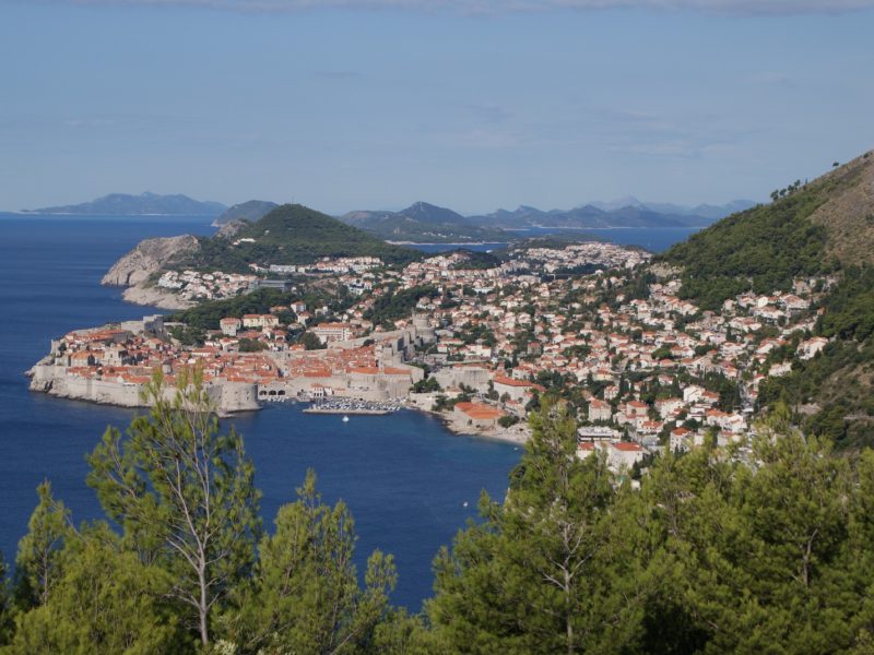Elevated view of Dubrovnik's walled old town surrounded by the blue Adriatic Sea