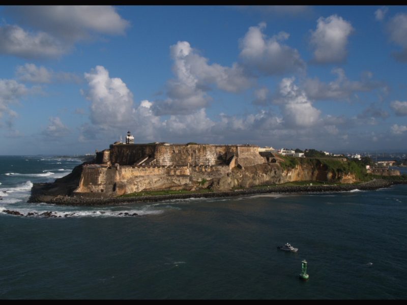 Castillo San Felipe del Morro fortress on a rocky point in San Juan, Puerto Rico, with waves breaking along the coastline